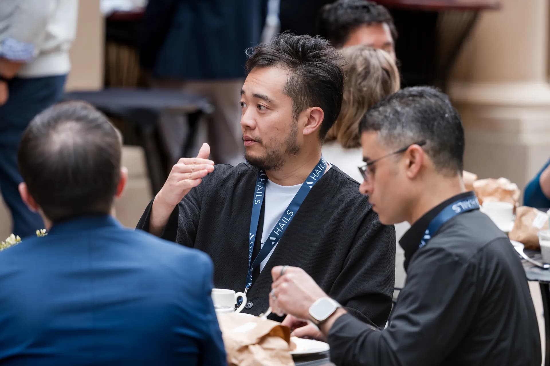 Attendees mid-conversation around a lunch table
